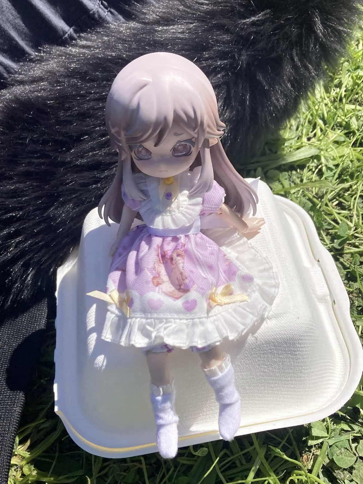 Teacup sits on a styrofoam box outside.