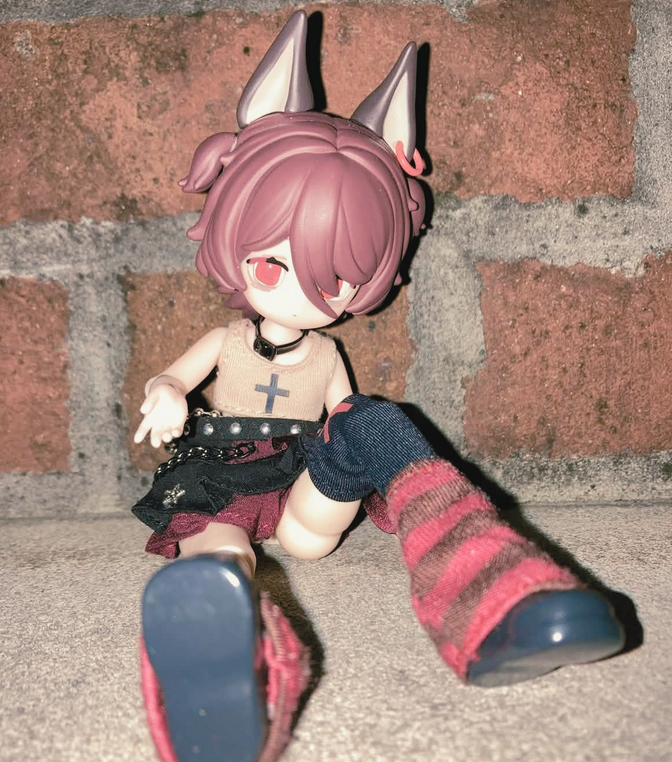 Elizabeth posing with brick behind her.