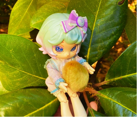 Taro holding an unbloomed Magnolia flower between her paws.